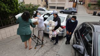 Officials and volunteers deliver diapers, supplies and toys to the St. Anthony Croatian Catholic Church where migrants have been transported in Los Angeles, June 14, 2023.