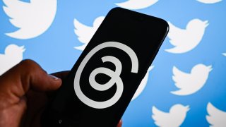 In this photo illustration, the Threads logo by META is displayed on a smartphone with Twitter logo in the background. Threads is the new social network from Meta Platforms which was launched on the 5th of July 2023.