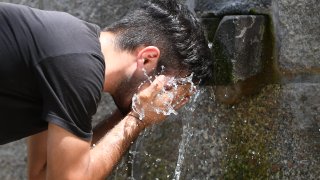 A young man cools his face in a public fountain on these scorching hot days on July 11, 2023 in Tempio Pausania, Sardinia, Italy. The record for the highest temperature in European history was broken in August 2021, when 48.8C was registered in Floridia, a town in Italy’s Sicilian province of Syracuse.