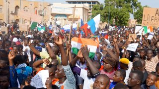 NIAMEY, Niger – July 30, 2023: Coup supporters take to the streets carrying Nigerien and Russian flags after the army seized power in Niger.