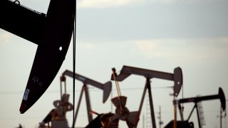 FILE – Pump jacks work in a field near Lovington, N.M., April 24, 2015.