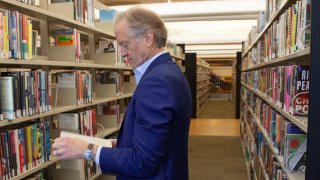 Nate Coulter, executive director of the Central Arkansas Library System (CALS), looks at a book in the main branch of the public library in downtown Little Rock, Ark., on May 23, 2023.