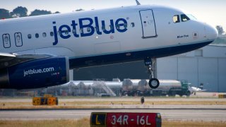 A Jet Blue aircraft takes off from Long Beach Airport in Long Beach, CA.