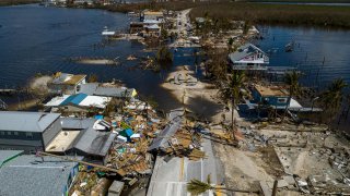 An aerial picture taken on October 1, 2022 shows a broken section of the Pine Island Road and destroyed houses in the aftermath of Hurricane Ian in Matlacha, Florida. 