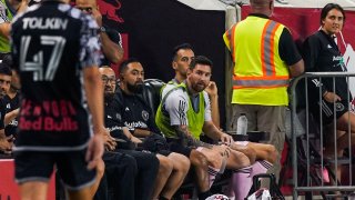 Inter Miami forward Lionel Messi, center right, watches from the bench during an MLS soccer match against the New York Red Bulls