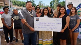 People pose during the announcement of new grants for Tribal Conservation Corps. The event was at the community garden of the Tuolumne Band of Me-Wuk Indians in July of this year.