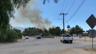 Smoke rises from a brush fire in the Agua Dulce area Tuesday Aug. 15, 2023.