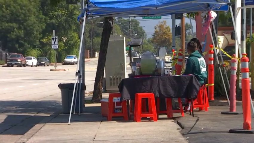 Street vendors set up on a sidewalk in Altadena.