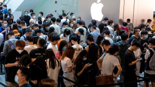 Customers line up to enter an Apple store as iPhone 14 series go on sale on September 16, 2022 in Shanghai, China.