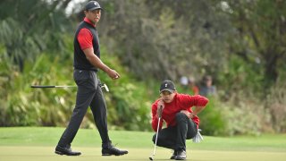 FILE - Tiger Woods and his son, Charlie Woods, read the third green during the final round of the PGA TOUR Champions PNC Championship at The Ritz-Carlton Golf Club on Dec. 18, 2022, in Orlando, Fla.