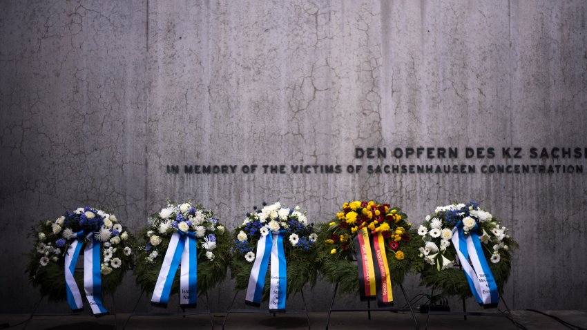 FILE – Wreaths at the memorial wall of the Nazi concentration camp Sachsenhausen after a ceremony marking the Holocaust Martyrs’ and Heroes’ Remembrance Day in Oranienburg, Germany, Tuesday, April 18, 2023.  German prosecutors say a 98-year-old man has been charged with being an accessory to murder as a guard at the Nazis’ Sachsenhausen concentration camp between 1943 and 1945. Nazis’ Sachsenhausen concentration camp between 1943 and 1945.