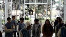 Photographs of people who disappeared during Argentina's dictatorship (1976-1983) are displayed on the wall where students walk through the ESMA Museum and Site of Memory in Buenos Aires, Argentina, Tuesday, Sept. 19, 2023. 