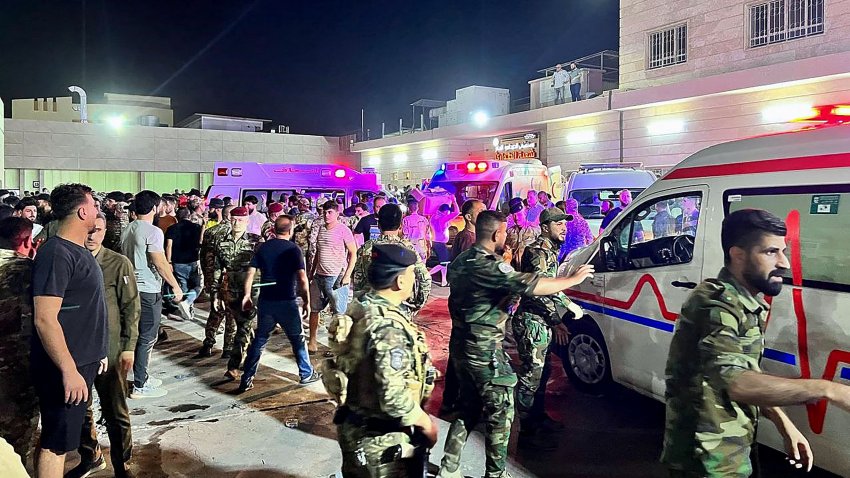 Soldiers and emergency responders gather around ambulances carrying wounded people after a fire broke out during a wedding at an event hall, outside the Hamdaniyah general hospital in Al-Hamdaniyah, Iraq on September 27, 2023. At least 100 people were killed and more than 150 injured when a fire broke out during a wedding at an event hall in the northern Iraqi town of Al-Hamdaniyah, according to state media and health officials, on September 27, 2023.