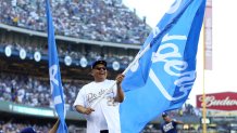 LOS ANGELES, CA - OCTOBER 24: Actor George Lopez waves a Dodger flag on top of the dugout prior to Game 1 of the 2017 World Series between the Houston Astros and the Los Angeles Dodgers at Dodger Stadium on Tuesday, October 24, 2017 in Los Angeles, California. (Photo by Rob Tringali/MLB via Getty Images)