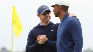 Rory McIlroy shakes hands with Tiger Woods on the 18th green after they completed a practice round prior to the 2023 Masters Tournament at Augusta National Golf Club in Augusta, Georgia, on April 3, 2023.