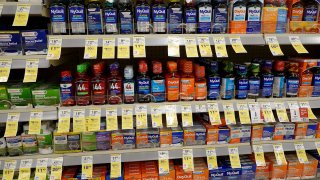 Cold and flu medicine including NyQuil sit on a store shelf in Miami on Sept. 12, 2023.