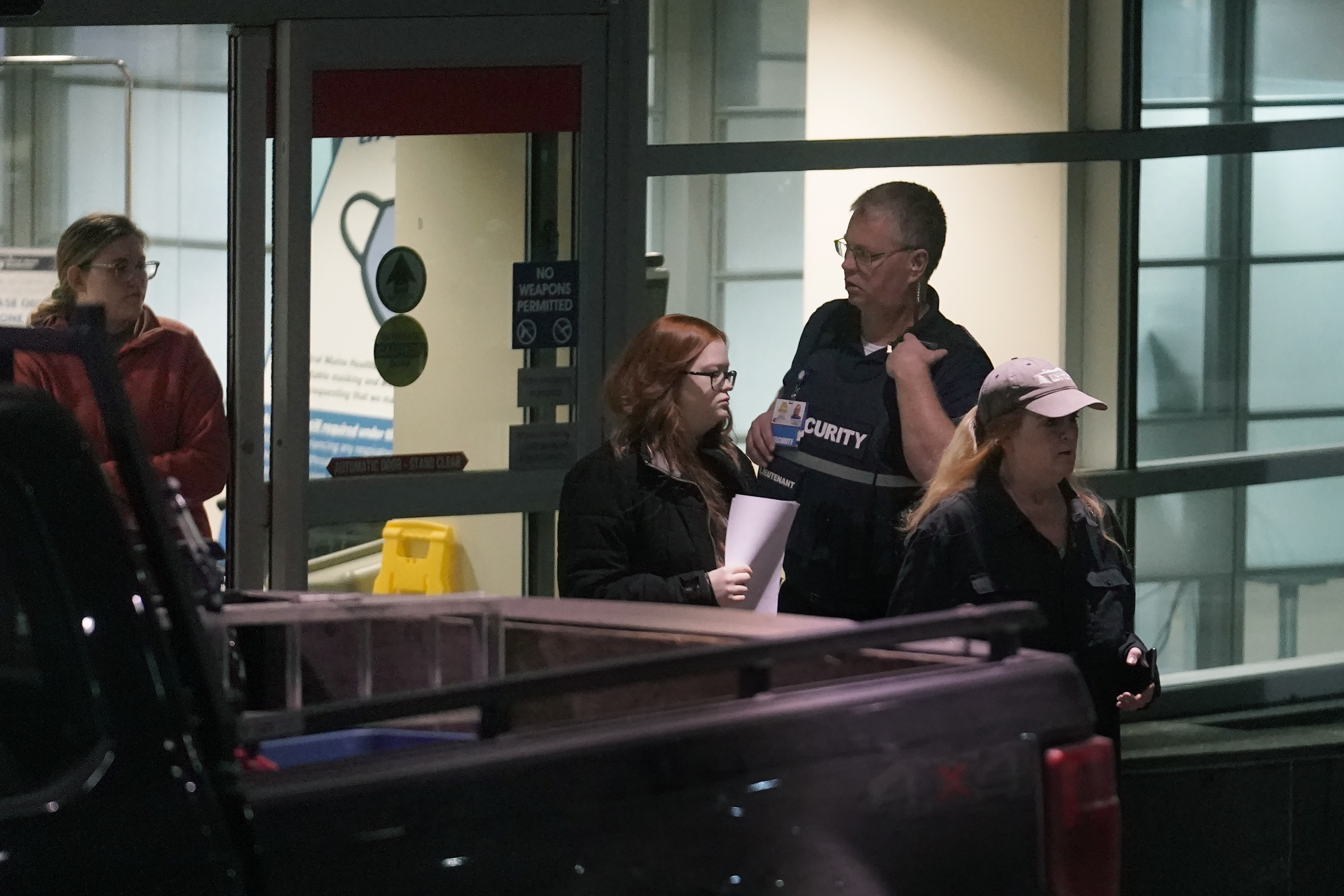 People depart an emergency department entrance at Central Maine Medical Center during an active shooter situation, in Lewiston, Maine, Wednesday, Oct. 25, 2023.