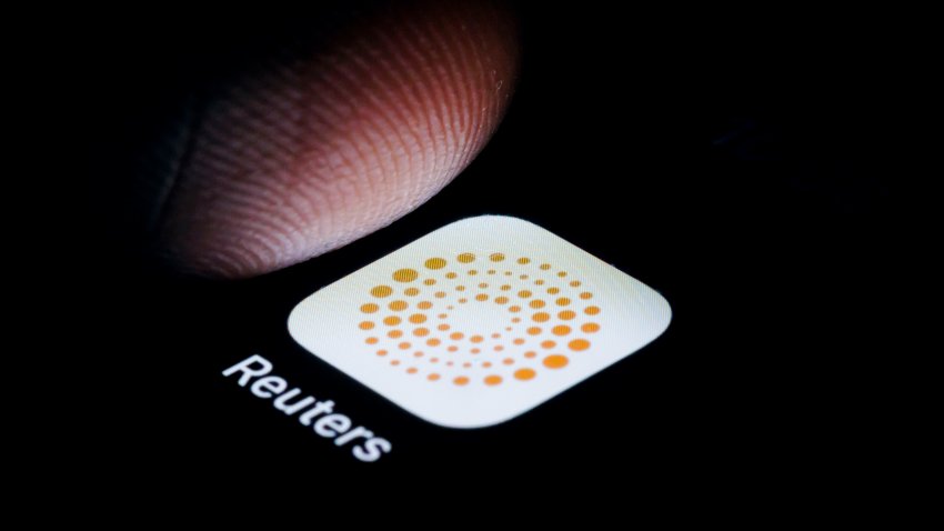 Finger tapping Reuters news app icon