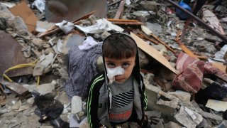 A boy stands among the rubble of buildings destroyed in an Israeli airstrike in the southern Gaza Strip city of Rafah, on Nov. 15, 2023. Israel has been carrying out attacks on Gaza over the past weeks and has imposed a siege on the enclave to retaliate against Hamas attacks on southern Israel. The conflict has so far led to the deaths of over 11,500 Palestinians in Gaza. On the Israeli side, about 1,200 people lost their lives, the majority of whom were killed in the Hamas attack on Oct. 7.