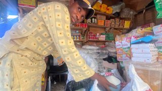 Abba Usman sells granulated sugar at his shop inside a market in Abuja, Nigeria, Friday, Oct. 27, 2023.