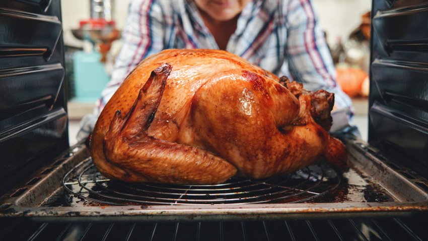 Picture of turkey cooking inside oven.