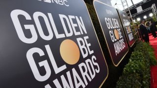Event signage appears above the red carpet at the annual Golden Globe Awards.