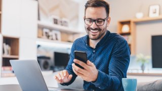 Young businessman working at home using lap top