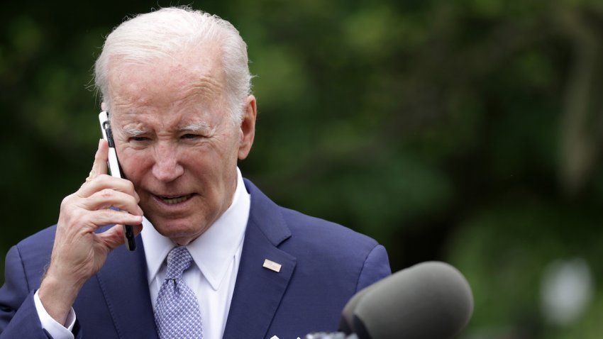 President Joe Biden talks on a cell phone during a Rose Garden event at the White House to mark National Small Business Week on May 1, 2023 in Washington, DC.