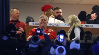 Singer-songwriter Taylor Swift and Jason Kelce #62 of the Philadelphia Eagles talk in a suite