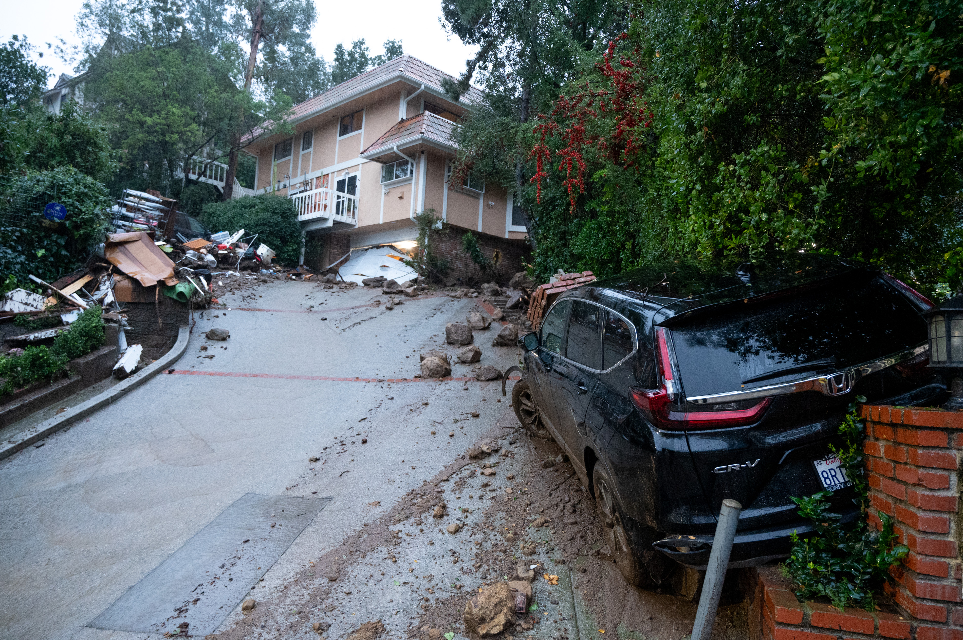 Studio City, CA – February 05:Storm damage from mud, rock and debris flows along Lockridge road in Studio City, CA,  has caused major damage to vehicles and houses in the area on Monday, February 5, 2024.  Rain is expected to continue in Southern California over the next 12 hours.   (Photo by David Crane/MediaNews Group/Los Angeles Daily News via Getty Images)