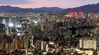 Commercial and residential buildings are illuminated at dawn in Seoul, South Korea, on Saturday, Oct. 21, 2023. South Korea has prepared a financial support program of 75.9 trillion won ($56.97 billion) for companies increasing investment in key sectors as well as small businesses struggling with the impact of high interest rates.