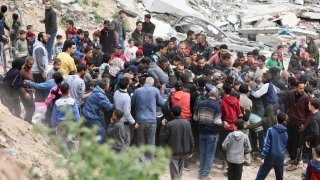 Palestinians rush to collect the humanitarian aid airdropped into Gaza City, Gaza Strip, on Sunday, March 17, 2024. (AP Photo/Mohammed Hajjar)