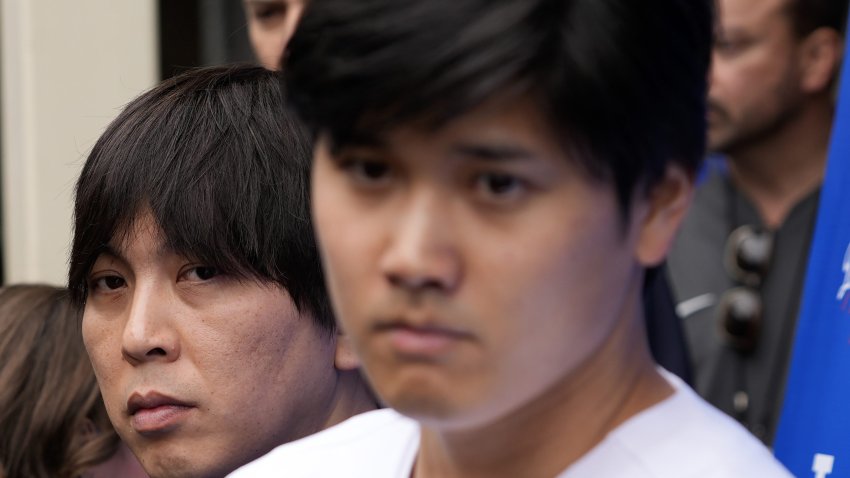 FILE -Ippei Mizuhara stands next to Japanese baseball star Shohei Ohtani and translates during an interview at Dodger Stadium on Feb. 3, 2024. Mizuhara has been fired by the Dodgers following allegations of illegal gambling and theft.