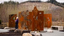 People visit the Oso Landslide Memorial for victims, Thursday, March 21, 2024, in Oso, Wash.