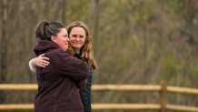 A woman comforts another as people arrive for the Oso Landslide Memorial dedication on the 10-year anniversary of the disaster, Friday, March 22, 2024, in Oso, Wash.