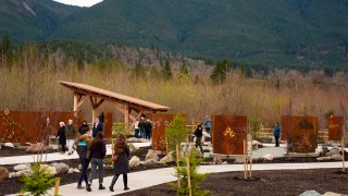 Family, survivors and community members visit the Oso Landslide Memorial before the official dedication on the 10-year anniversary of the disaster, Friday, March 22, 2024, in Oso, Wash.