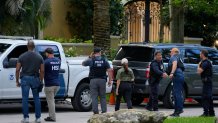 Law enforcement agents stand at the entrance to a property belonging to rapper Sean "Diddy" Combs, Monday, March 25, 2024.