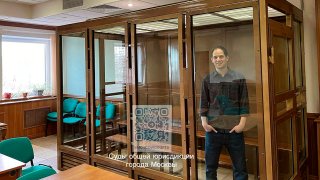 In this photo released by the Moscow City Court Press Service, Wall Street Journal reporter Evan Gershkovich stands in a glass cage in a courtroom at the Moscow City Court in Moscow, Russia, Tuesday, March 26, 2024. A Moscow court has ordered Wall Street Journal reporter Evan Gershkovich to remain in jail on espionage charges until at least late June. (Moscow City Court Press Service via AP)