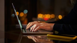 File – Man typing on laptop