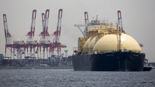 A liquefied natural gas tanker sails past a container terminal as it arrives in Yokohama, Japan, May 21, 2018. 