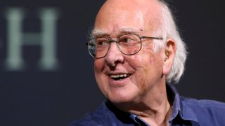 FILE – Britain’s Professor Peter Higgs smiles during a press conference in Edinburgh, Scotland, on Oct. 11, 2013.