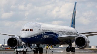 FILE – Boeing employees walk the new Boeing 787-10 Dreamliner down towards the delivery ramp area at the company’s facility after conducting its first test flight at Charleston International Airport, Friday, March 31, 2017, in North Charleston, S.C.