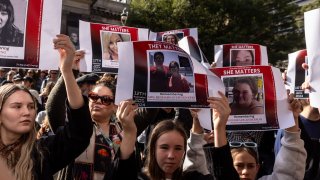 People gather at the State Library of Victoria during a rally