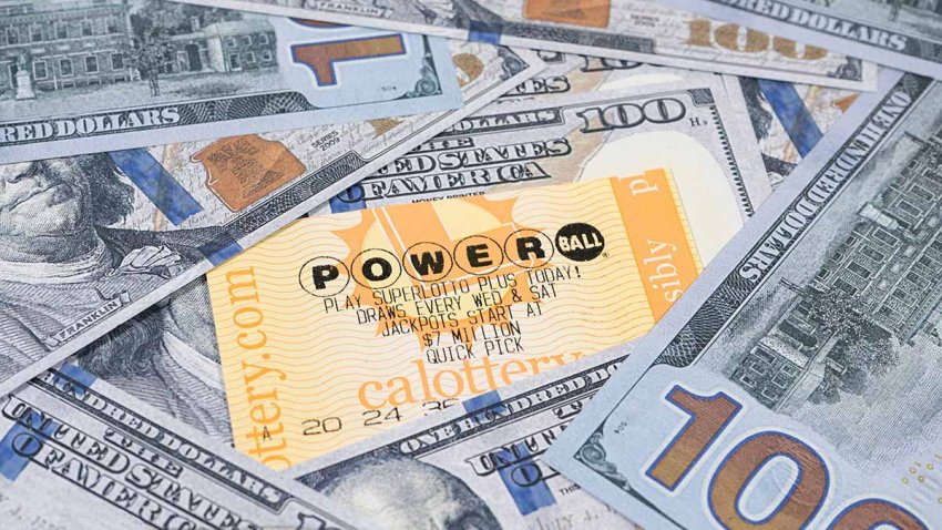 Lake Elsinore, CA, USA – September 30, 2023: Focus on a Powerball lottery tickets surrounded by US currency.