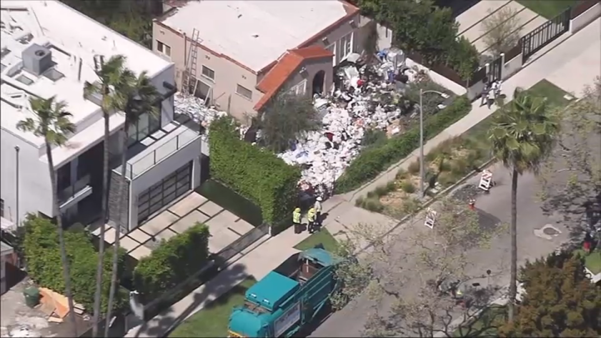 LA begins removing piles of trash from Fairfax home