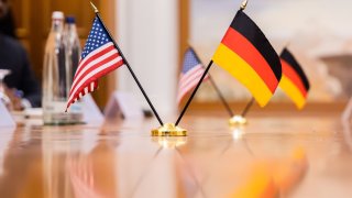 The flags of the U.S. and Germany are on the table at a bilateral meeting between German Economics Minister Habeck and U.S. Secretary of State Blinken at a hotel on the Gendarmenmarkt. Photo: Christoph Soeder/dpa (Photo by Christoph Soeder/picture alliance via Getty Images)