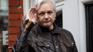 File - Julian Assange gestures as he speaks to the media from the balcony of the Embassy Of Ecuador on May 19, 2017 in London, England.