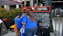 Fans take cards during The 2024 Topps Truck Tour promotion outside of Dodger Stadium on Friday, May 3 in Los Angeles, California.