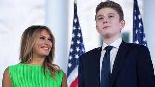 First lady Melania Trump (L) looks at her son Barron Trump after U.S. President Donald Trump delivered his acceptance speech for the Republican presidential nomination on the South Lawn of the White House August 27, 2020