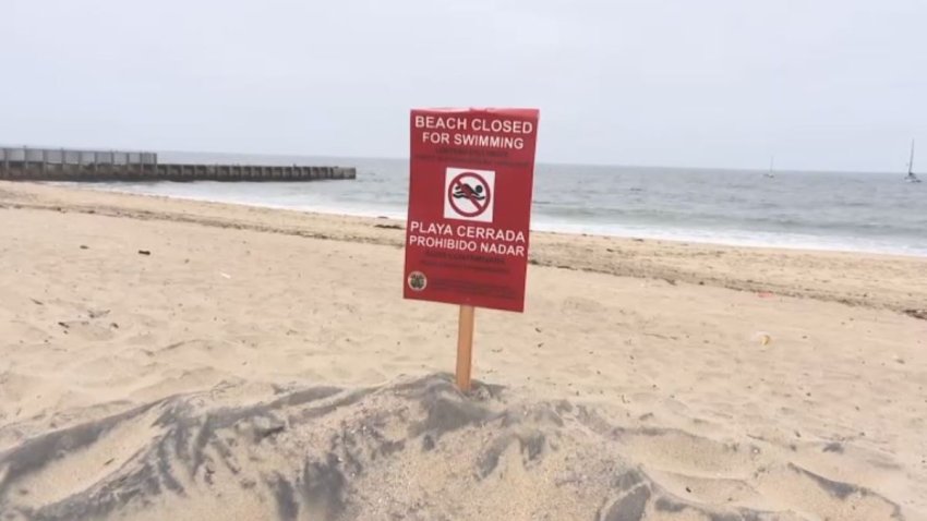 A sign warns beach visitors to stay out of the water.